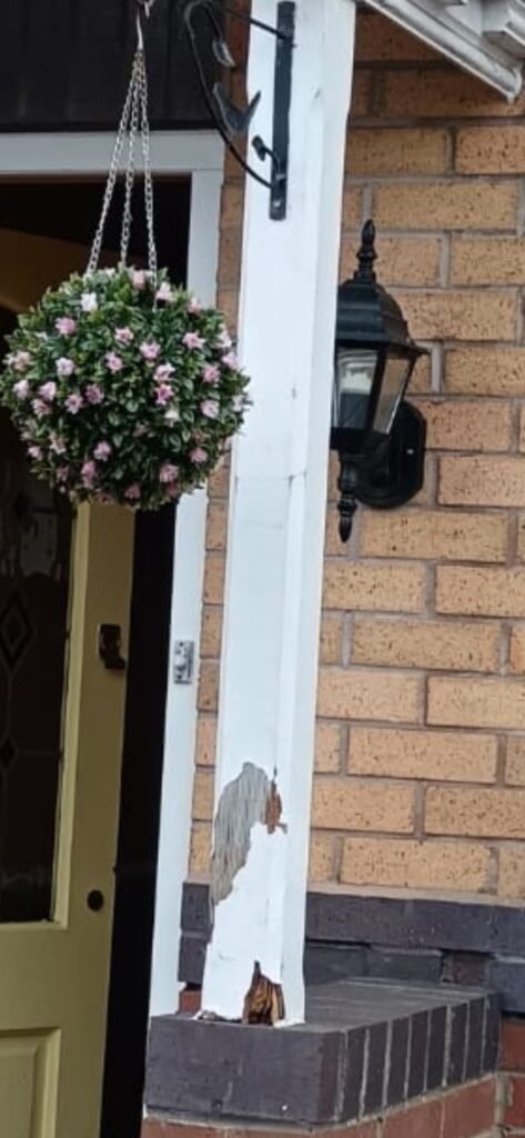 Rotten timber porch post with decay at the base before replacement.